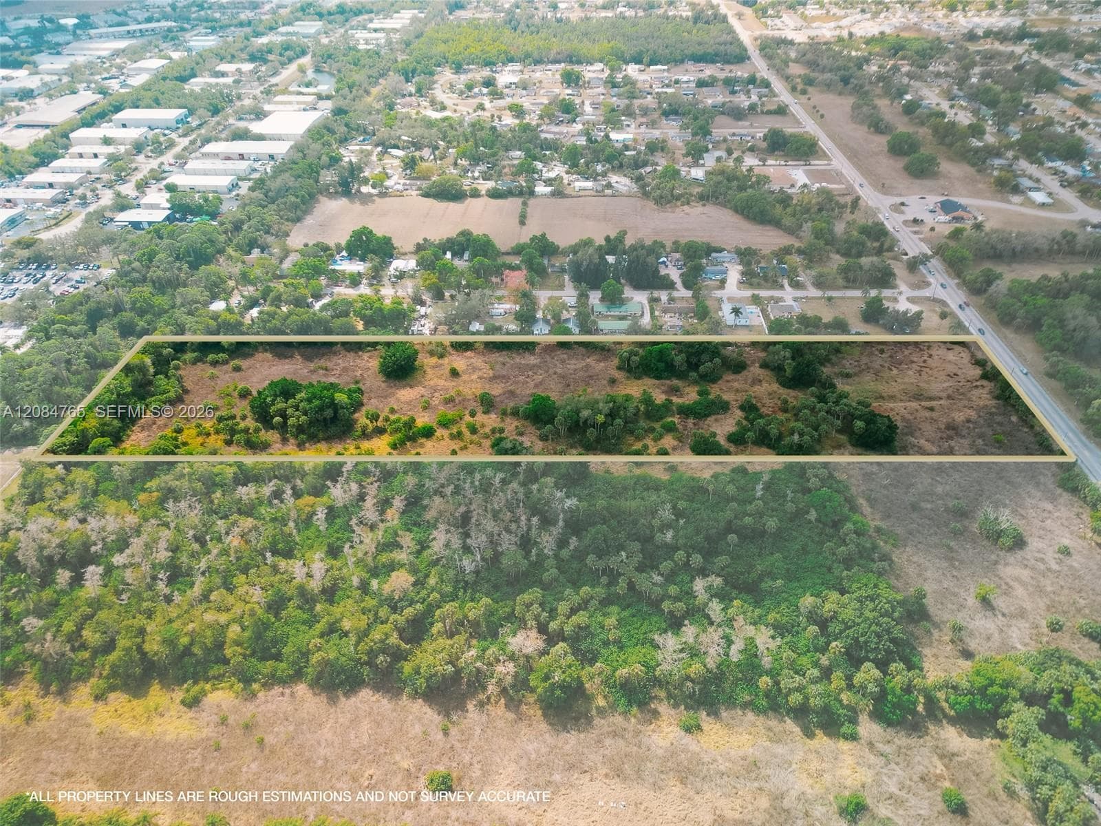 Aerial perspective highlighting the wooded boundaries of this buildable vacant lot, surrounded by lush greenery and close proximity to an established neighborhood.