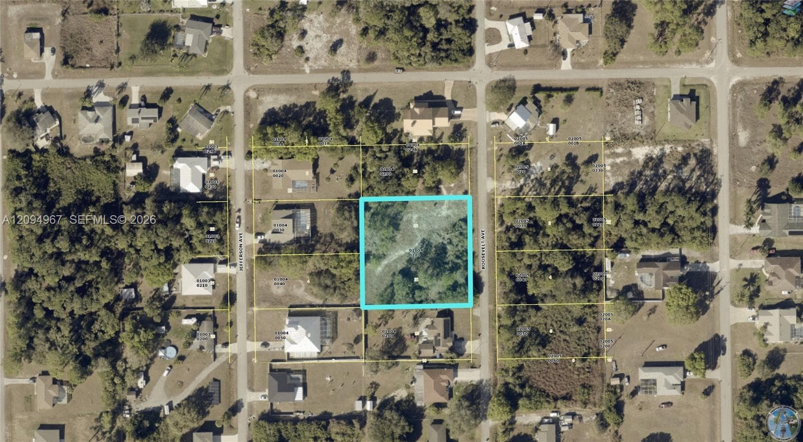 Aerial overview showcasing this rare 1-acre double lot surrounded by established homes in growing Lehigh Acres.